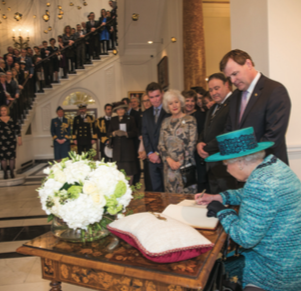 The Queen signs the guest book